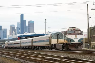 Amtrak train with downtown Seattle in background.