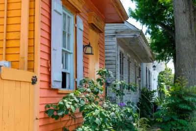 Close-up angled view of colorful wood clapboard small historic homes with chipping paint in New Orleans, Louisiana.