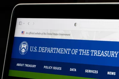 Close-up of laptop screen with U.S. Treasury Dept. website pulled up.