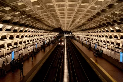 View from above platform in D.C. Brutalist subway station with people waiting on platforms