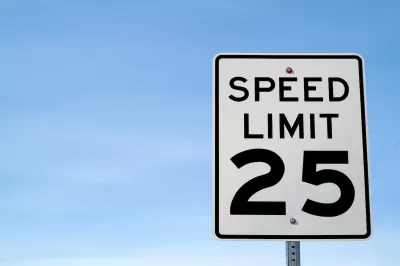 CLose-up on black and white 25 mph speed limit sign.
