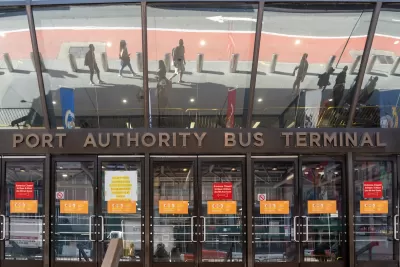 Entrance to Port Authority Bus Terminal with glass doors and sign in midtown Manhattan, New York City.