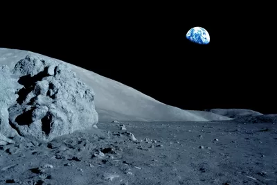 Gray moon surface with black sky and Earth in the background.