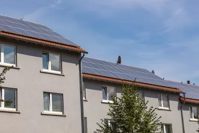 Solar panels on roof of grey residential building
