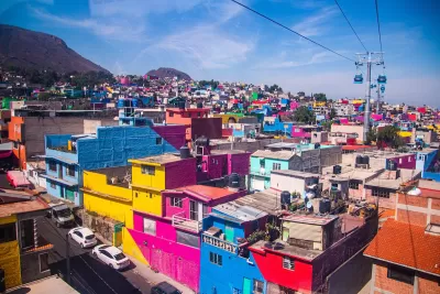 View of colorful dense buildings in Mexico City from aerial cable car.