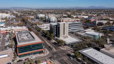 Aerial view of downtown Chandler, Arizona with desert hills in background.