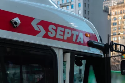 Close-up of SEPTA logo in white letters on red line at top of SEPTA bus in Philadelphia, Pennsylvania.