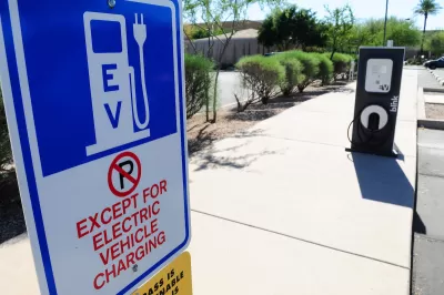 Close-up of EV charging station sign with "No Parking except for EV charging" in outdoor parking lot.