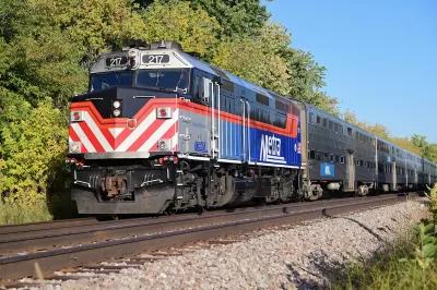 Chicago Metra heavy rail commuter train on track with trees in background.