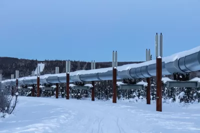 Silver oil pipeline running above ground in snowy area near Fairbanks, Alaska.