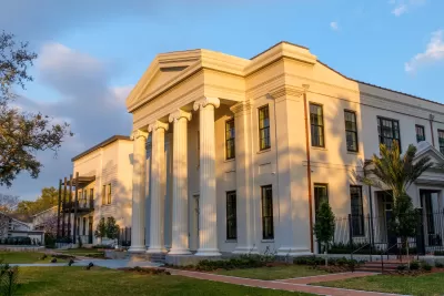 View of renovated Greek Revival Carrollton Courthouse at golden hour with new construction building next to it