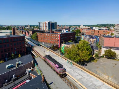 Aerial view of purple MBTA commuter train at station in Lynn, Massachusetts.