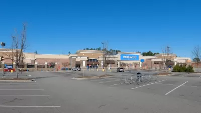 Large Walmart store with empty parking lot.