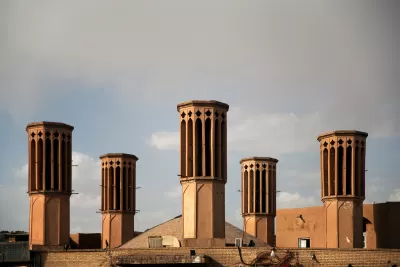 Elevated view of five windcatcher ventilation towers on rooftops in Yazd, Iran.