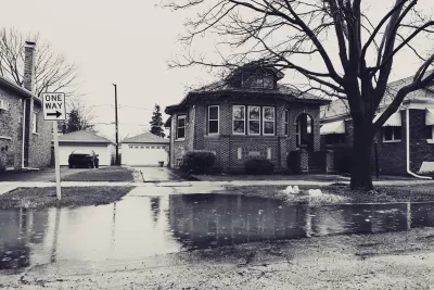 Sepia-toned photo of flooded street with residential home