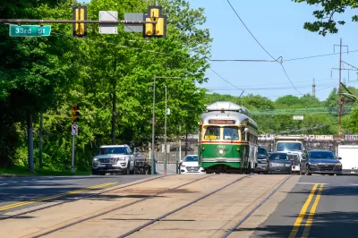 Vintage green Phialdelphia trolley moving down street