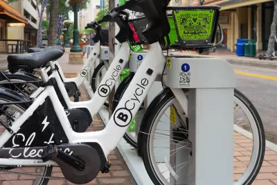 B-cycle bike share station with white bikes on street in San Antonio, Texas.