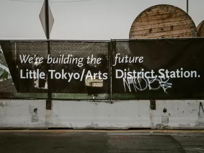 Black banner with white text "We're building the future - Little Tokyo/Arts District Station" in Los Angeles, California.