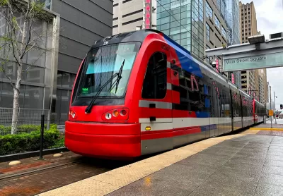 Red light rail train at outdoor platform in downtown Houston, Texas