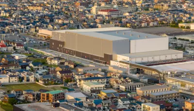 Aerial view of large warehouse in neighborhood.
