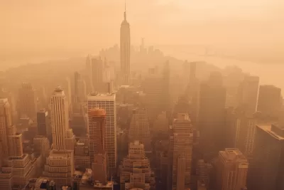 Aerial view of New York City including Empire State Building blanketed in orange wildfire smoke