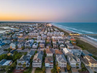 Aerial view of dense neighborhood with beach homes on coast in Wrightsville Beach, North Carolina.