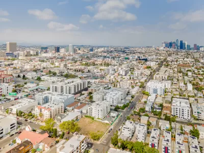 Aerial view of Koreatown neighborhood in Los Angeles with downtown skyline in background.
