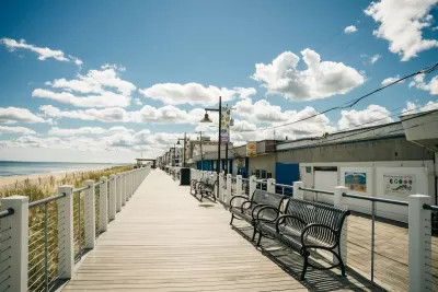 Wooden beachside boardwalk with benches in Salisbury, Massachusetts.