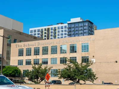 School District of Philadelphia building with large silver title lettering and taller buildings visible in background.