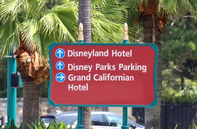 CLose-up of red outdoor sign for Disneyland Hotel, Disney Parks Parking, and Grand Californian Hotel in Anaheim, California.