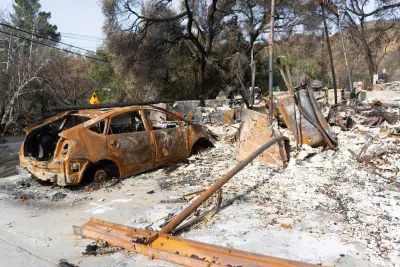 Burned car and home in Los Angeles after 2019 wildfire.