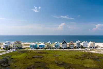 Row of colorful two-story beach homes on Gulf Coast beach in Alabama.