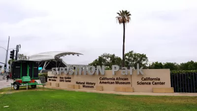 Expositoin park enrtance sign in Los Angeles, California with tall palm tree in background.