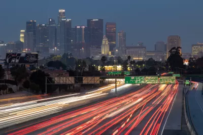 Early morning view of downtown Los Angeles with blurred heavy traffic on Interstate 10 in foreground.