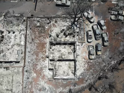 Aerial view of destroyed home and cars after Lahaina, Hawaii wildfires.