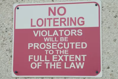 Red and white "No Loitering" sign.