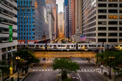 A view straight down LaSalle Street, lined by high-rise buildings with an El line running horizontally over the street.