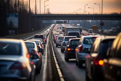 Heavy traffic at standstill on freeway at dusk.