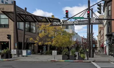 View of Ithaca Commons sign over pedestrian street in downtown Ithaca, New York.