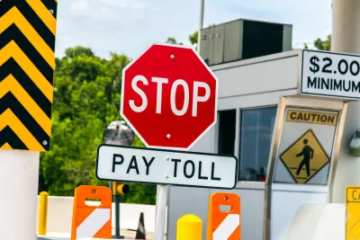 Freeway toll booth with "Stop" and "Pay Toll" signs
