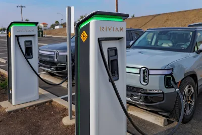Two Rivian trucks charging at Rivian branded charging ports.