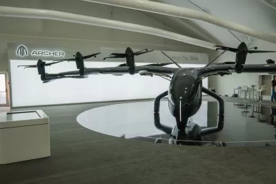Archer Aviation Midnight eVTOL aircraft on display at Dubai Airshow November 13th 2023, dark colors, bright background, indoors. Electric aircraft, electric helicopter.