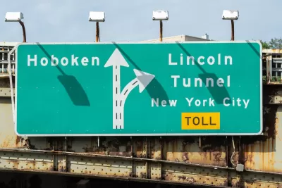 Close-up of green and white sign for Lincoln Tunnel and Hoboken.