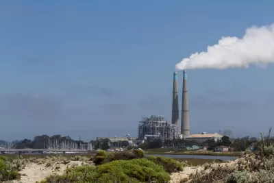 View of natural gas power plant with two tall smokestacks on Northern California coast