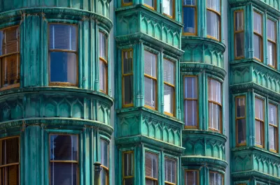 Close-up of historic building with green facade and curved windows in San Francisco, California.