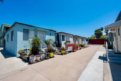 Colorful bright blue small houses with decorative cacti in courtyard in San Diego, California.
