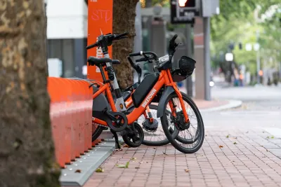 Orange Biketown bike share bikes parked at station on sidewalk in Portland, Oregon,