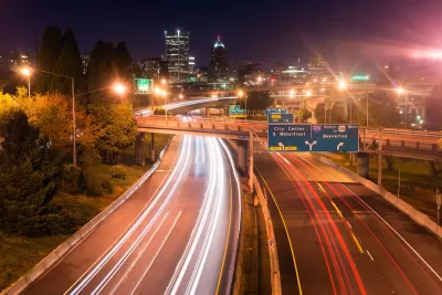 View of blurred traffic lights on Interstate 5 freeway heading into Portland, Oregon at night.