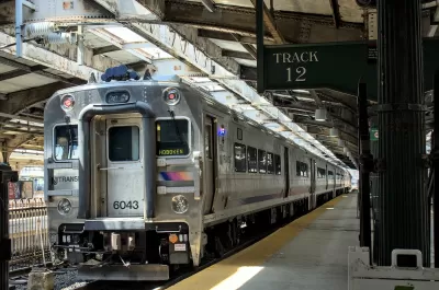 New Jersey Transit passenger rail commuter train at station in Hoboken, New Jersey with platform 12 sign.