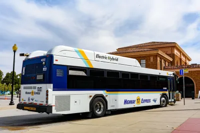 White and blue hybrid electric public transit bus in San Jose, California.